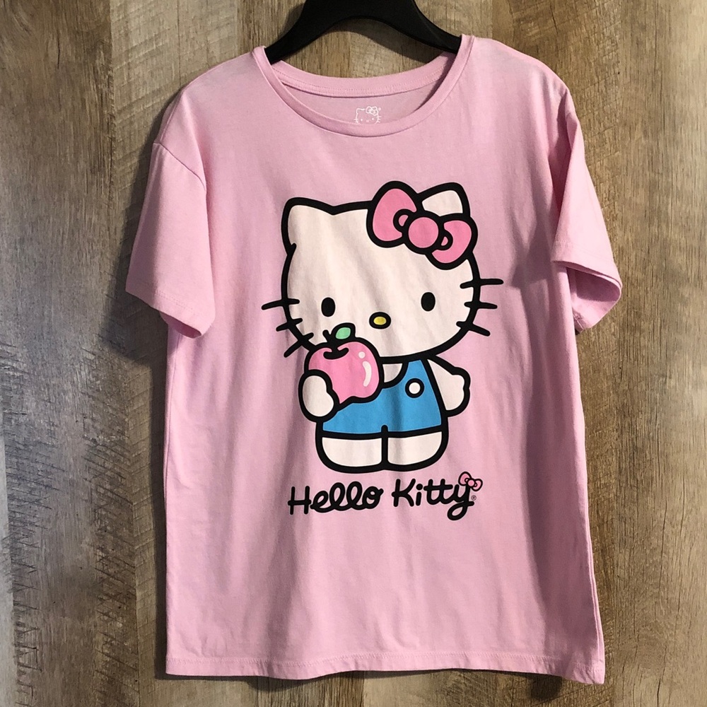 Hello Kitty Pink Graphic Tee with Blue Outfit holding apple